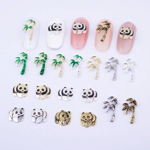 Detailed view of panda and bamboo alloy nail charms with green enamel for DIY manicure