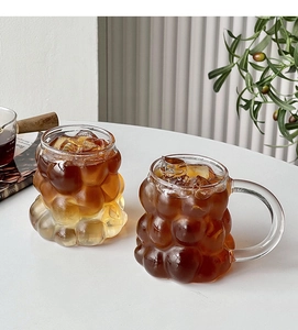Detailed view of grape-shaped heat-resistant borosilicate glass cups with iced coffee