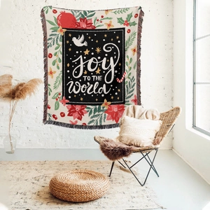 Detail of Christmas woven throw blanket featuring Joy to the World text and holiday motifs