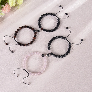 Detail of heart magnet connectors on natural stone bead bracelets for couples