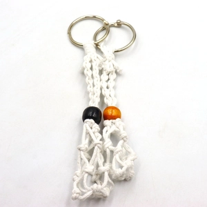 Detail of handmade macrame keychain net pouch with orange and black wooden beads
