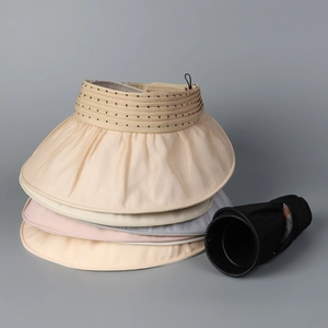Detail showing the flexible, foldable brim of the organza sun hat for easy portability