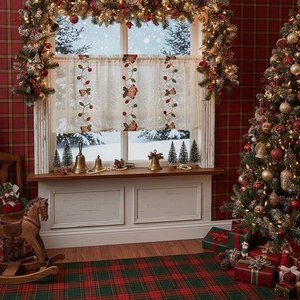 White lace Christmas cafe curtain with festive bell embroidery in a cozy winter room