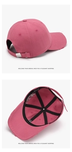 Detail of rose red cotton baseball cap showing frayed brim and adjustable metal buckle