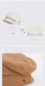 Detail of plush octagonal baker boy hats featuring side metal snap buttons and warm texture