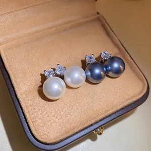 Elegant pearl earring set with white and grey pearls and cubic zirconia in a jewelry box