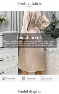 Close-up of champagne silk robe featuring black piping details and elegant waist tie