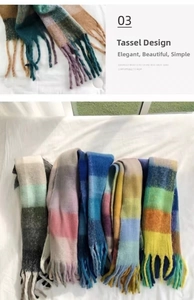 Detail view of colorful rainbow plaid scarf with soft fringe tassels and plush texture