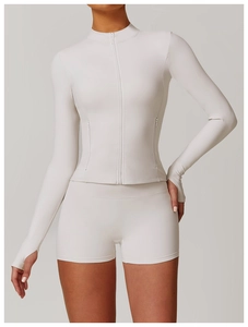 Detailed close-up of cream white fitness jacket showing zipper and thumb hole cuffs