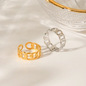 Detailed view of adjustable gold and silver chain link rings on a minimalist white surface