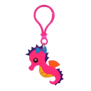 Detail of a seahorse PVC keychain with blue bow and pink body for party favors