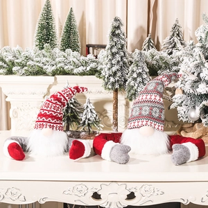 Red and grey Christmas gnome plush toppers with snowflake hats on white mantel decor