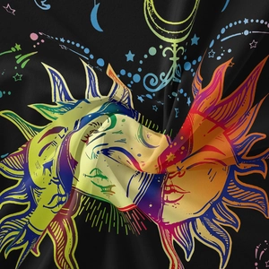 Close-up detail of celestial sun and moon patterns on soft bohemian tapestry fabric