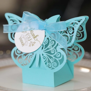 Close-up of light blue laser-cut candy box with butterfly detail and Thank You tag