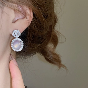 Détail de boucles d'oreilles fleurs en cristal avec pendentifs ovales en pierre de lune lavande
