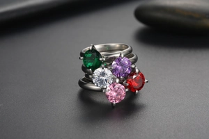 Macro view of five-color stackable titanium rings with six-prong zircon settings