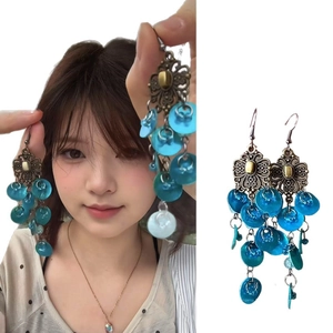 Peacock blue bohemian tassel earrings with bronze floral base and layered shell pendants
