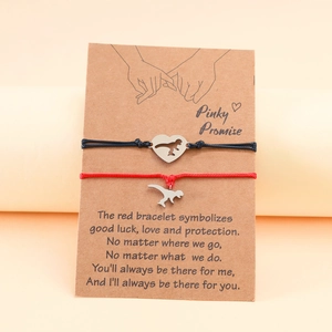 Close-up of dinosaur heart woven bracelets on a sentimental message display card
