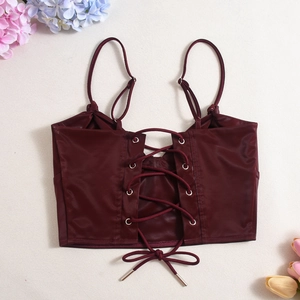 Detailed view of burgundy satin crop top with adjustable straps and lace-up front detail