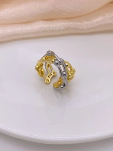 Close-up of dual-tone hollow woven ring in gold and silver finish with bead details