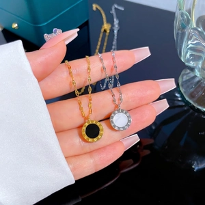 Roman numeral stainless steel necklace with black and white shell pendants in gold and silver