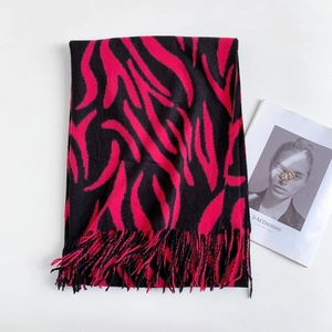 Detailed view of knitted zebra stripe scarf in pink and black with elegant fringe trim