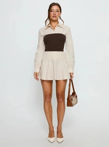 Detail of elegant striped dress set featuring wide brown waist corset and chic handbag