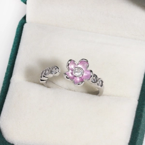 Detail of pink flower ring with white zircon stones and adjustable silver band