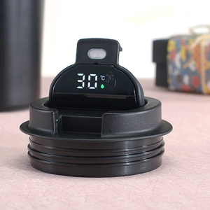 Detail of smart coffee mug lid with digital LED temperature display and screw threads