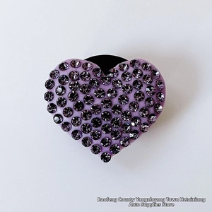 Detailed close-up of a heart-shaped car air vent clip with purple sparkling rhinestones