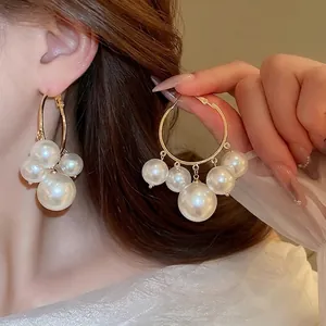 Elegant gold hoop earrings with cascading white pearls for a sophisticated women's look