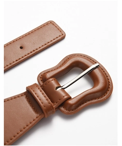 Close-up of brown PU leather belt showing the buckle detail and fine stitching texture