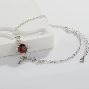 Detailed macro shot of S925 sterling silver stamp on heart garnet charm bracelet