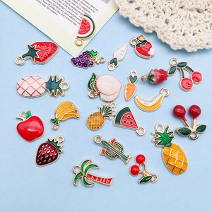 Macro detail of various colorful fruit and plant enamel charms for DIY jewelry making