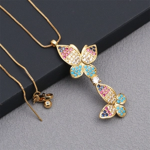 Detail of gold double butterfly necklace with colorful micro-paved cubic zirconia stones