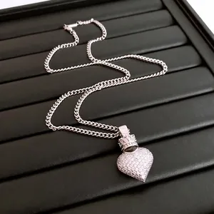 Sparkling zircon heart pendant necklace with crown detail on elegant silver-tone chain
