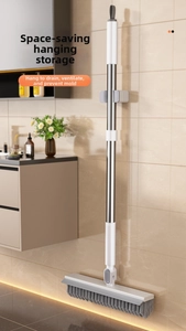 Wall-mounted long handle floor brush with gray bristles and squeegee for bathroom storage