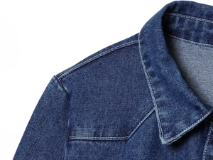 Close-up of shoulder and collar stitching on a dark blue denim jacket with washed texture