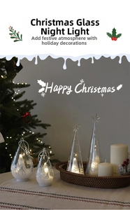 Detail of cone and teardrop glass Christmas ornaments with LED warm lighting effect