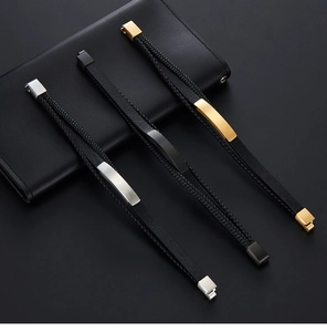 Detail of multilayer braided leather bracelets for men with gold, silver and black clasps