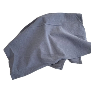 Folded dark blue textured table mat with cotton linen weave and visible stitching