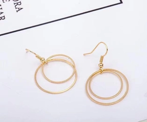 Detailed view of minimalist gold double hoop earrings with a sleek metallic finish