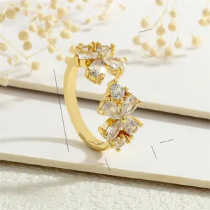Macro detail of leaf ring showing brass finish and zircon flower petals decoration