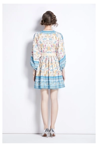 Full back view of a bohemian floral dress featuring puff sleeves and a cinched high waistline