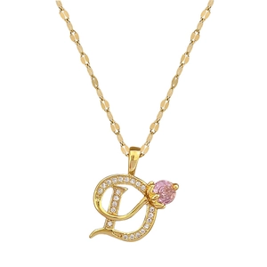 Luxurious gold D-letter pendant necklace with sparkling crystals and a pink gemstone