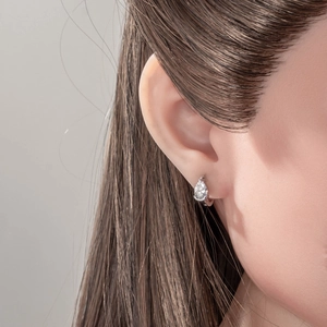 Water drop zircon hoop earrings in minimalist style shown on model's ear in high detail