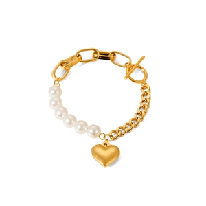 Gold chain pearl bracelet with heart pendant and OT clasp on a white background