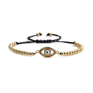 Adjustable woven bracelet with gold beads and a colorful zircon evil eye charm centerpiece