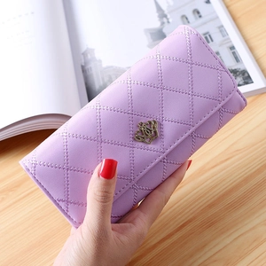 Close-up of light purple quilted long wallet with golden crown heart buckle detail
