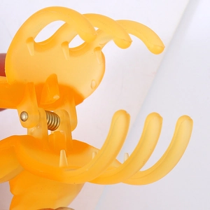 Matte orange large butterfly hair claw clip with strong metal spring on white background